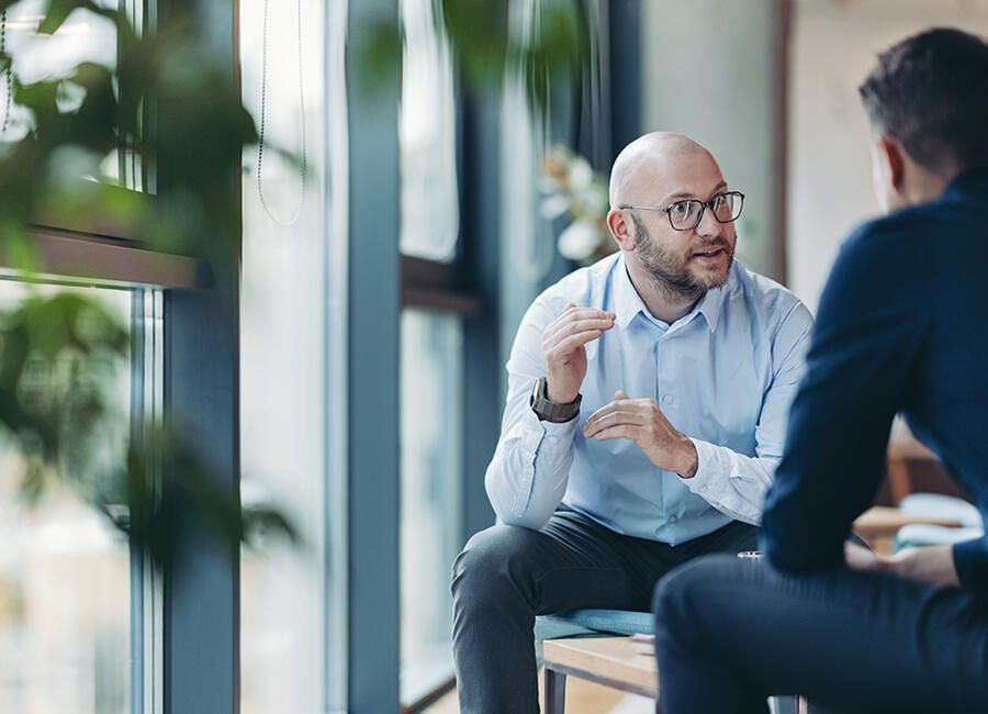 Men talking by Window