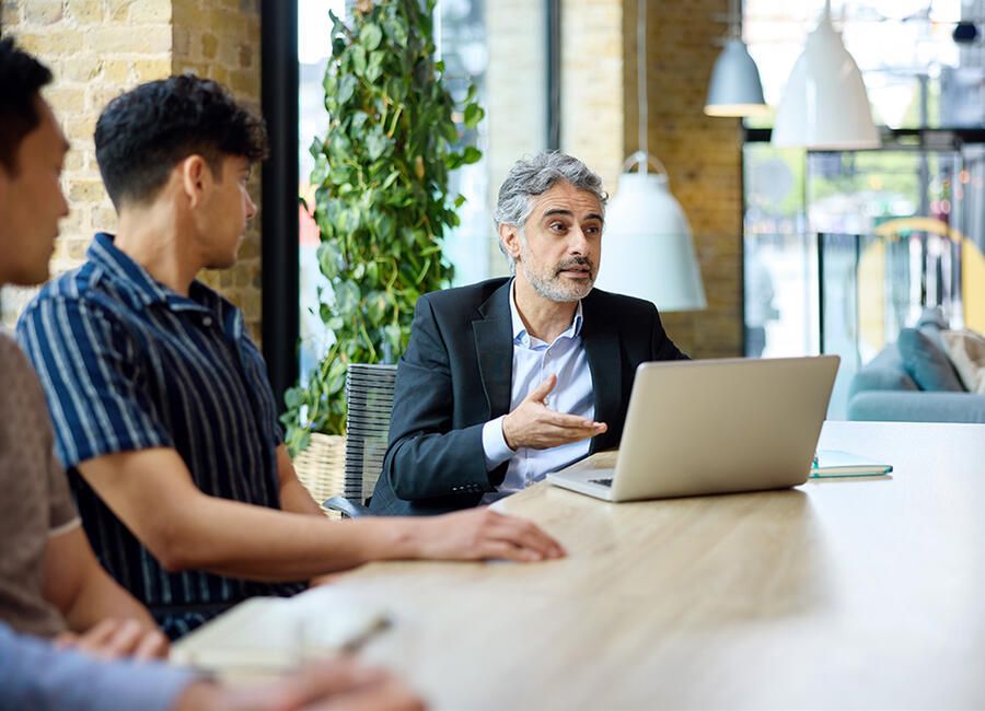 Man Speaking with laptop at table