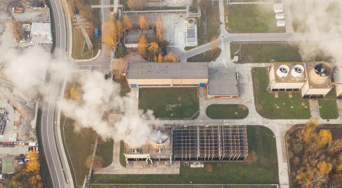 white smoking coming out of industrial building
