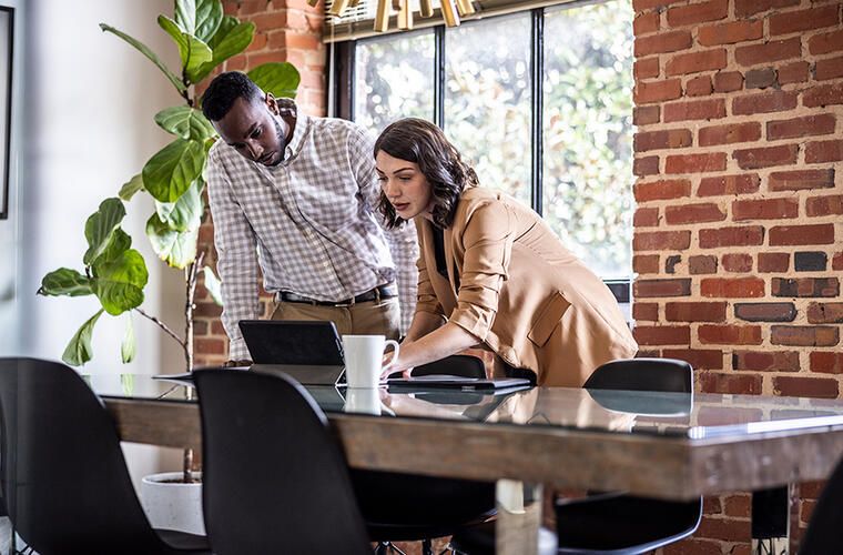 Two people looking at laptop