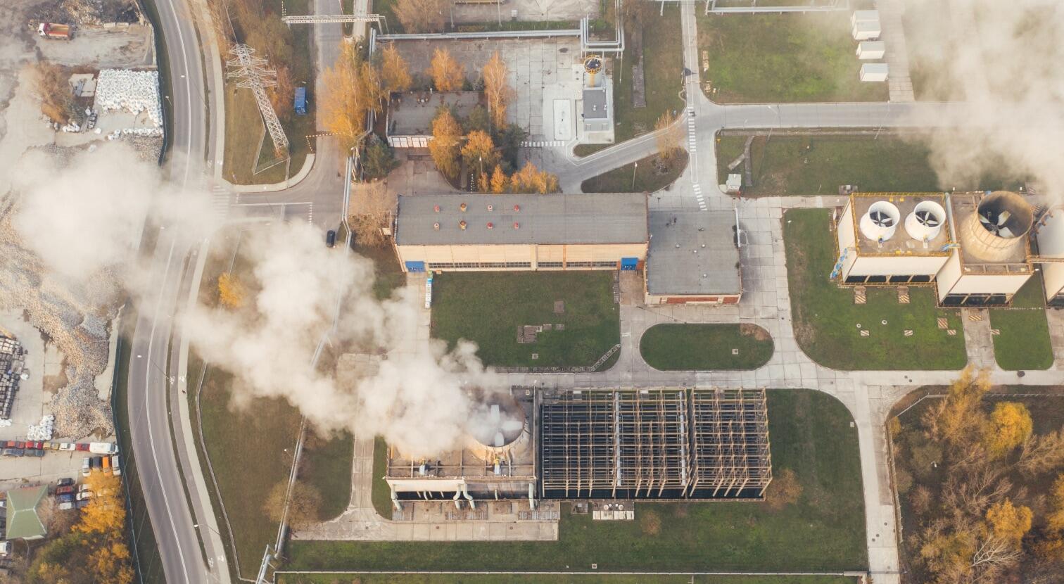 white smoking coming out of industrial building