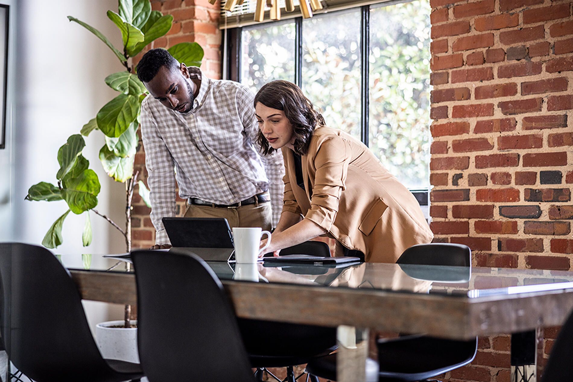 Two people looking at laptop